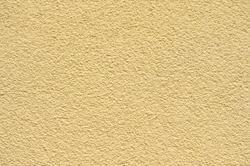 the wall is decorated with yellow plaster