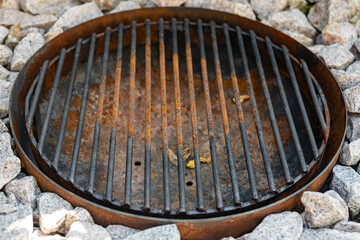 a rusty grill on a stone floor