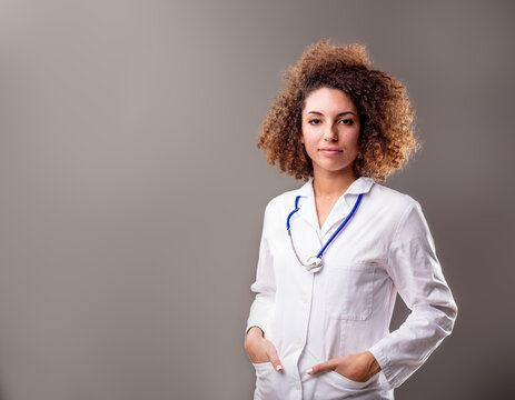 portrait of a south-american doctor in white coat as a medical doctor ready to serve her patients