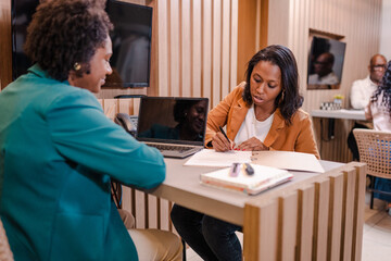 Brazilian customer signing a bank loan agreement at a bank branch in Brazil