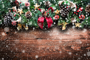 Merry Christmas Frame with Snow and real wood green pine, colorful baubles, knots with berries and...
