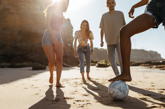 Happy Millennial Diverse People Students Playing Soccer Ball, Enjoy Summer Vacation, Have Fun On Beach