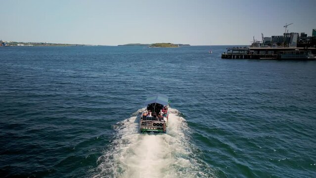 Aerial View of an Amphibious Tour Bus Floating in the Ocean off the Coast of Halifax Canada. Drone Shot Following an Amphibious Boat with Tourists Floating and Receding at the Waterfront.