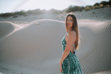 Chica morena guapa en un ambiente de playa y arena en el sur de españa