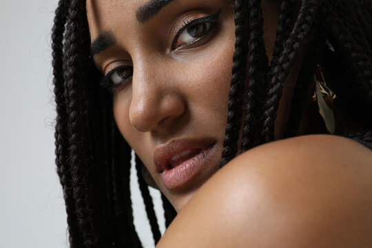 Close-up portrait of African American young woman with long dark braids. Mock-up