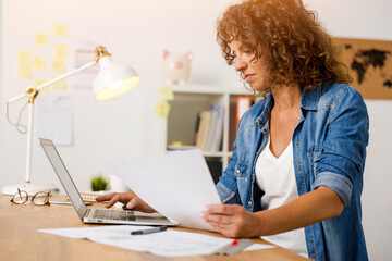 Middle age woman working at the office