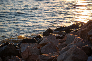 The sunset on the river, the rocky shore
