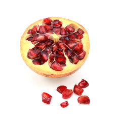 Cut half pomegranate cross section with seeds removed and spilled on white background