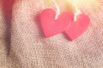 Couple of decorative wooden red hearts for Valentine's day on canvas background