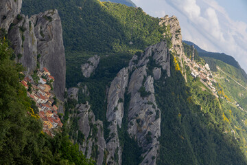 Fototapeta premium View of Pietrapertosa and Castelmezzano. Two beautiful villages built on the Lucanian Dolomites in Italy. Connected by a zipline that crosses the valley adrenaline-pumping experience. Day and sunset.