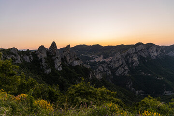 Fototapeta premium View of Pietrapertosa and Castelmezzano. Two beautiful villages built on the Lucanian Dolomites in Italy. Connected by a zipline that crosses the valley adrenaline-pumping experience. Day and sunset.