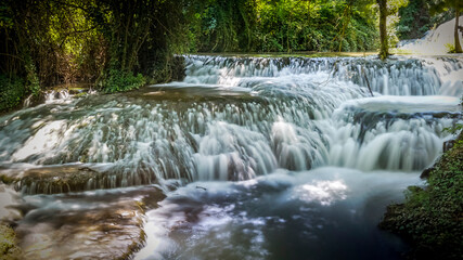 Fototapeta premium Stone monastery garden park with lush waterfalls