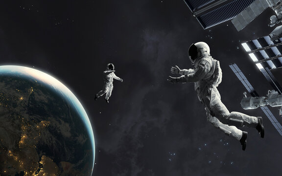 3D illustration of astronaut saving his colleague at deep space. Space walk. 5K realistic science fiction art. Elements of image provided by Nasa