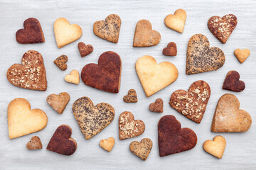 Love concept. Variety of heart cookies on grey rustic background