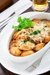 Delicious dumplings with mushroom sauce in a bowl