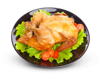 Roasted chicken on plate isolated on white background with lettuce and tomatoes