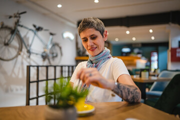 One woman senior caucasian female sit at cafe have a cup of coffee