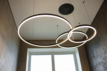 Modern ceiling lamp of three rings in the interior.