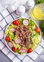 Salad with beef tongue and vegetables. Top view