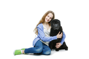 Beautiful smiling teen age girl hugging black shar pei dog. Isolated on white background. Copy...