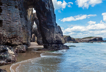 Natural rock arches on Cathedrals beach  in low tide (Cantabric coast, Lugo (Galicia), Spain).
