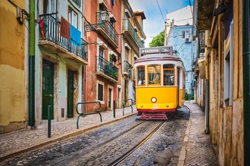 Fototapete Rund Enge Straßen Famous vintage yellow tram 28 in the narrow streets of Alfama district in Lisbon, Portugal - symbol of Lisbon, famous popular travel destination and tourist attraction  © Dmitry Rukhlenko