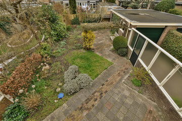 the back garden from above, with some plants and shrubs in the fore - image is taken from an aerial view
