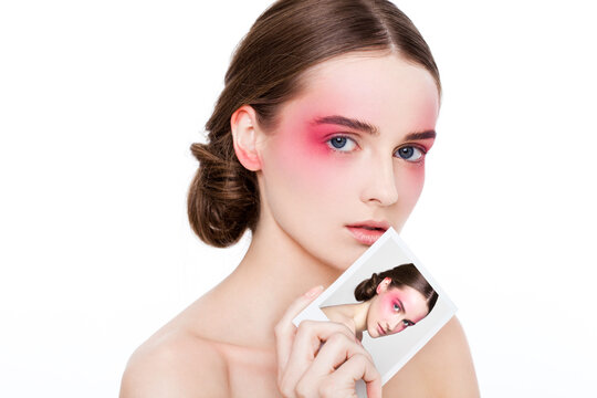 Beauty makeup pink eyes and lips fashion model holding polaroid photo with  on white background