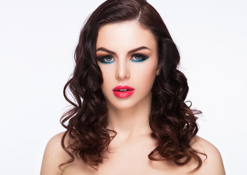 Beauty blue eyes red lips makeup fashion model with curly hair on white background