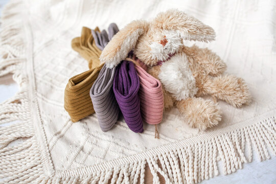 Children's clothing folded on a chair with a soft toy. The house is in order. High quality photo