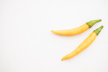 Yellow hot chili peppers on white background
