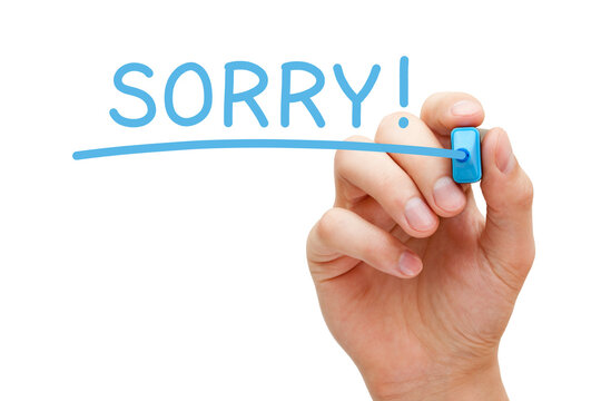 Hand writing Sorry with blue marker on transparent glass board isolated on white.