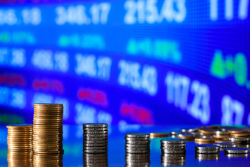 stack of coins forming a bar chart on a graph, investment concept, financial market