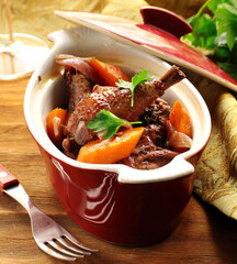 slow stew the cock in red wine with vegetables