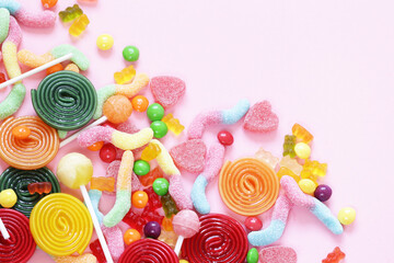 Fototapeta na wymiar Colorful candy and fruit jelly jujube on a pink background