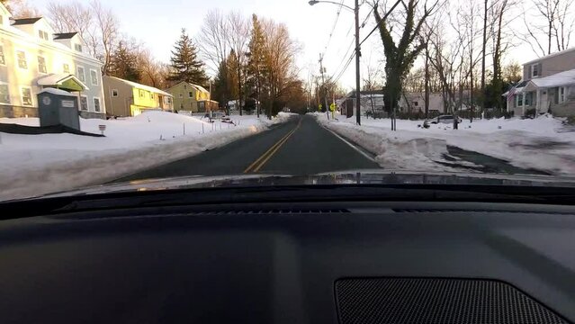 time-lapse driving through suburban town covered with snow after the storm in February
