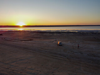 breathtaking sunset over a salt lake, with hues of orange and pink colors