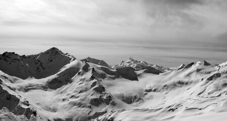 Black and white panorama of Caucasus Mountains in snow winter evening. Elbrus Region. View from Elbrus.
