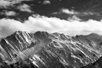 Obraz premium Black and white snow winter mountains and cloud sky in sun evening. Caucasus Mountains. Svaneti region of Georgia.