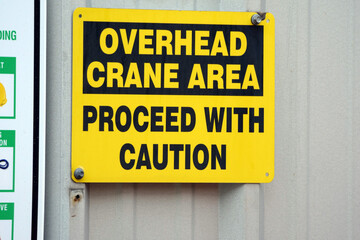 Overhead crane caution sign at factory.