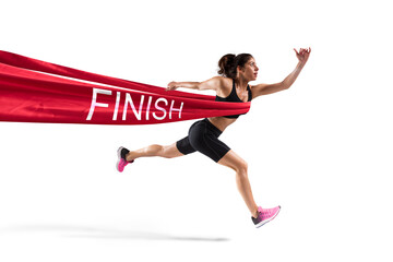 Athletic woman goes beyond the red ribbon at the arrival of a race