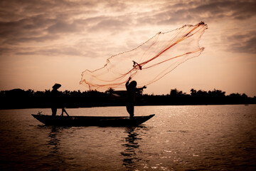Vietnamese fisherman throwing a net