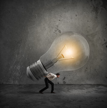 Businessman holds a big light bulb. Have a great idea to be realized concept