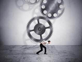 Businessman holding with fatigue a gears system mechanism