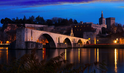 Pont Saint-Benezet and catholic Cathedral in Avignon in night lights, France