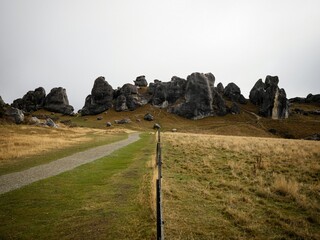 Nature landscape panorama of limestone boulder rocks in dry grass vegetation at Castle Hill in...