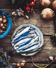 Fresh sardines. Fish with vegetables. Mediterranean fish on plate