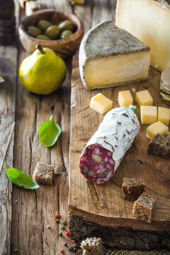 Cheese and Salami. Variety od cold cuts. Cheese on wood. Types of cheese and sausages