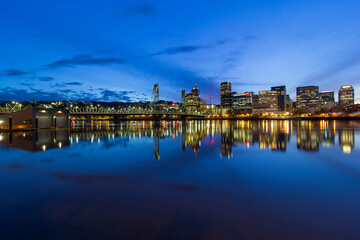 Fototapeta na wymiar Portland Oregon downtown city skyline by Hawthorne Bridge over Willamette River waterfront during evening blue hour