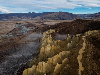 Aerial panorama of Omarama Clay Cliffs geological natural erosion silt and sand rock formation in Canterbury New Zealand